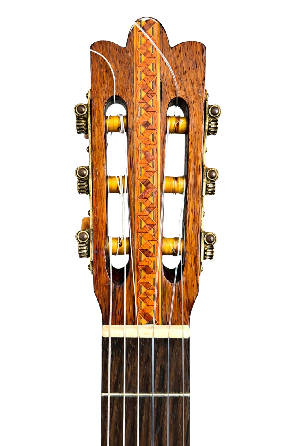 Headstock front showing hand-inlaid marquetry strip of alternating diamond lozenges