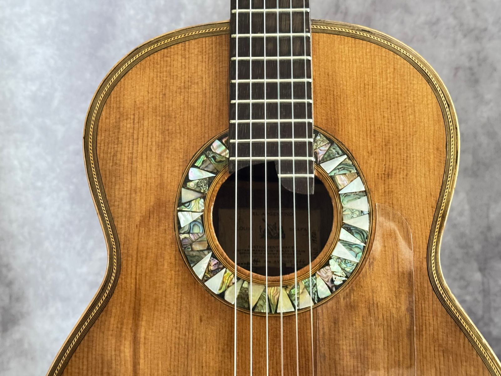Close-up of hand-cut abalone rosette around the soundhole
