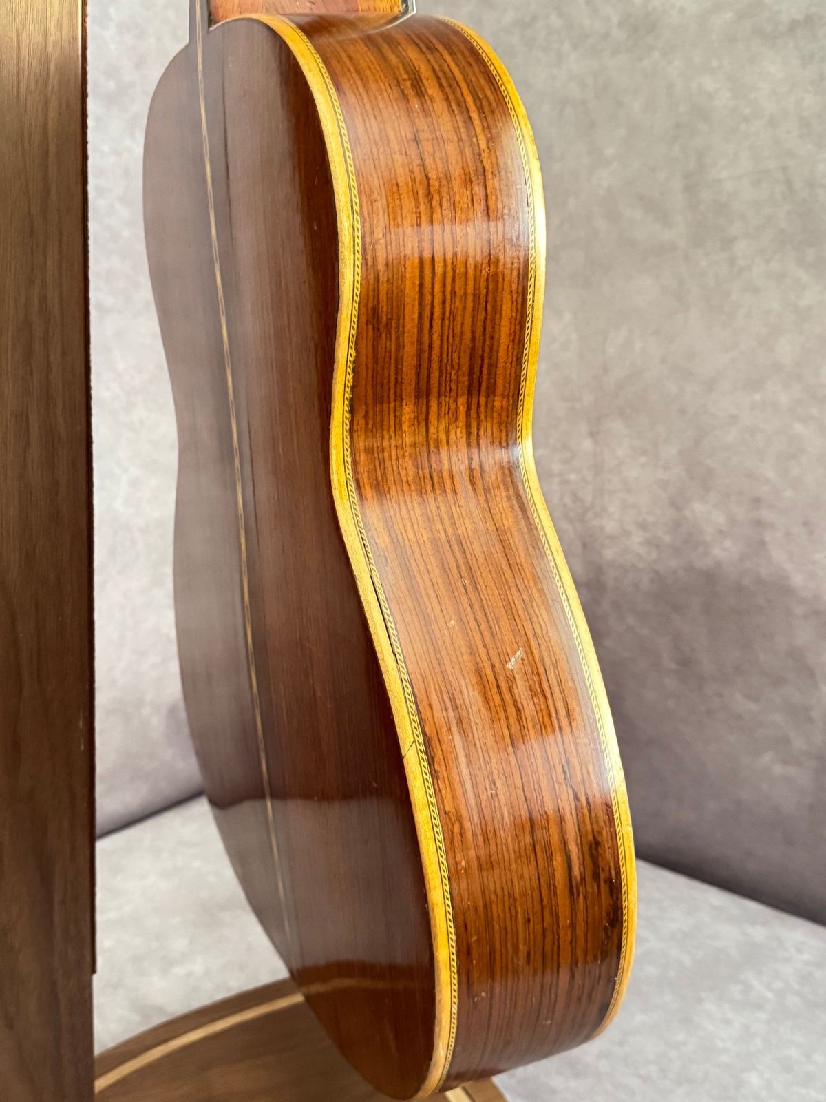 Side profile showing figured rosewood and multi-layer rope binding